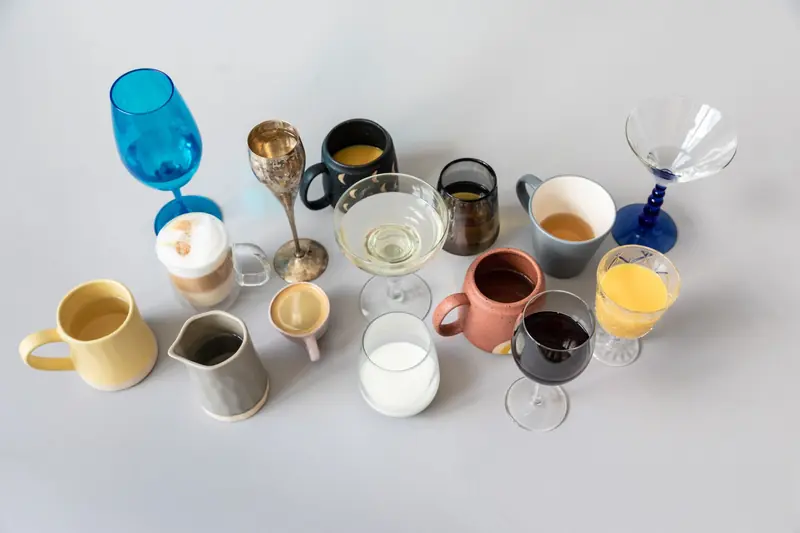A variety of drinks displayed in colorful cups and glasses from an overhead view