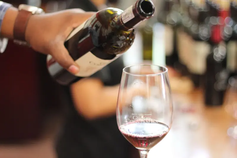 Close-up of red wine being poured into a glass in a Cape Town restaurant