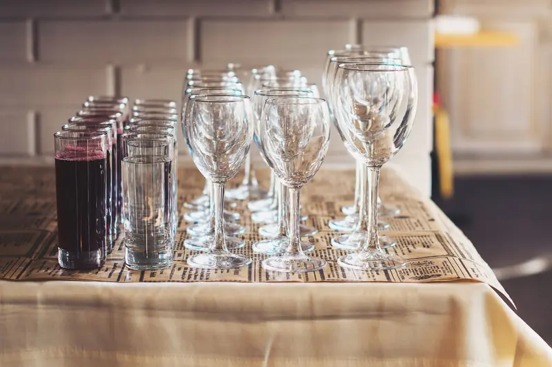 Close-up of wine and water glasses arranged on a table in a cozy restaurant setting